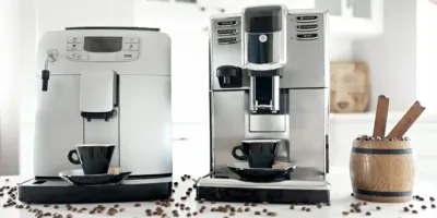 Two coffee makers with two black cups, ready to make a delicious home-brewed coffee